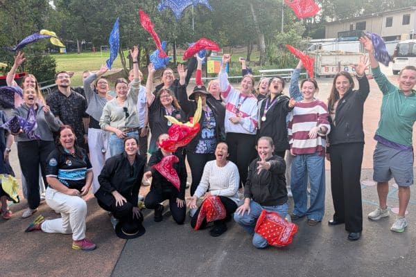 Enthusiastic group celebrating at the end of The Scramble, throwing colourful bandanas in the air and cheering