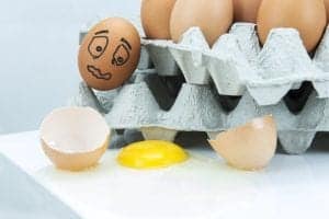 An egg falling out of an egg carton