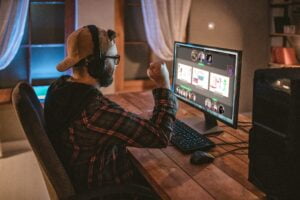 man playing the go game on desktop computer