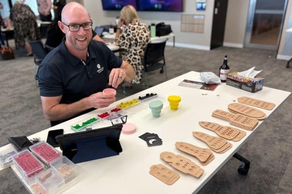 Pinnacle Team Events facilitator setting up Before Mars board game