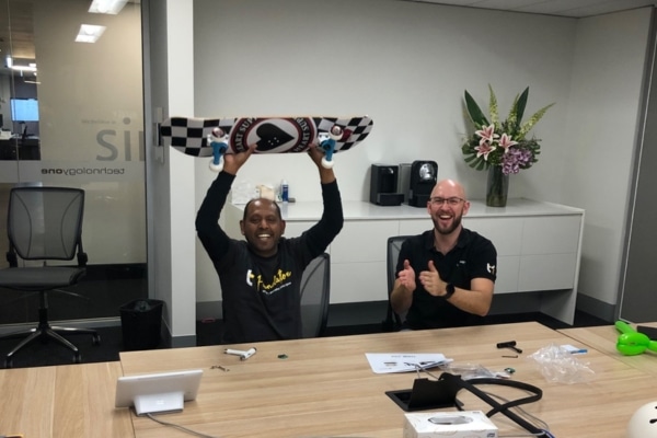 Two males celebrating after building a skateboard