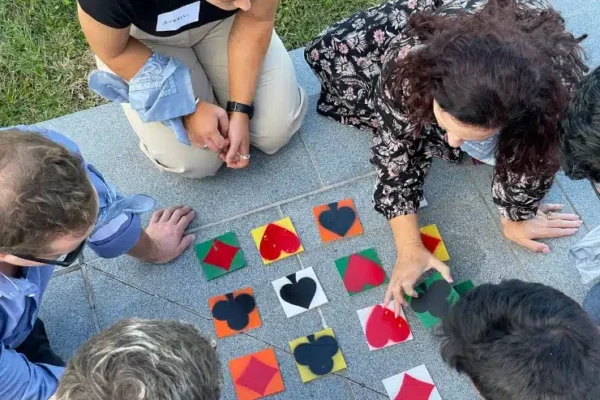 PTE_Ransom_Tiles_Owned birdeye of people working out a tile game