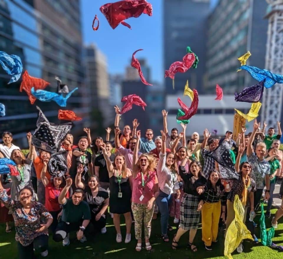 Group of Pinnacle Team Events attendees celebrating and throwing bandanas in the air