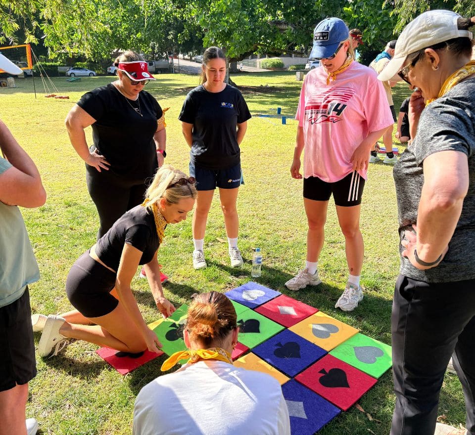 People outside working together to finish puzzle
