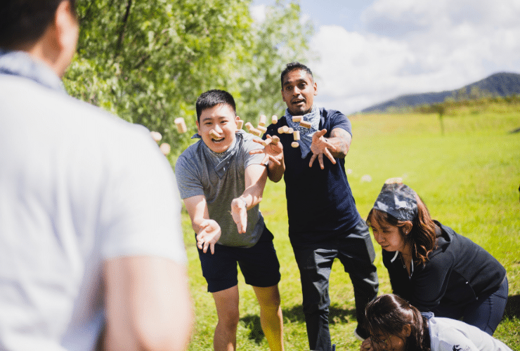 Person throwing wine corks to another team member to catch