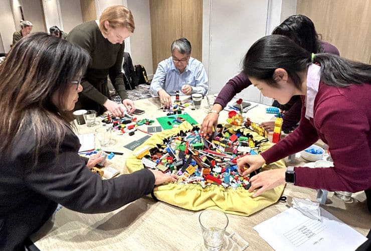 Group of people at table doing lego serious play
